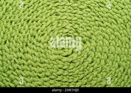 Knitted background close up. green woolen fabric macro Stock Photo
