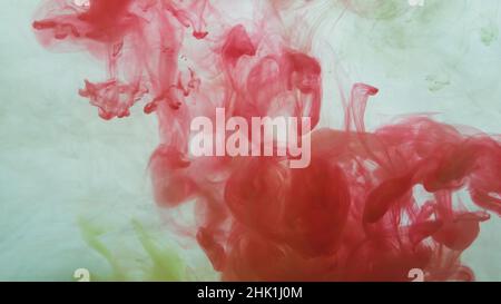 Red paint in the water. ink in fluid. abstract background. colorful splashes in liquid Stock Photo