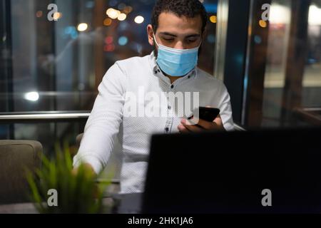 Successful black businessman holding plastic card making transaction using mobile banking application Stock Photo