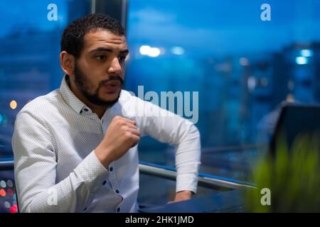 Virtual meeting with many people together. African-American young guy talking online with employees via video connection Stock Photo