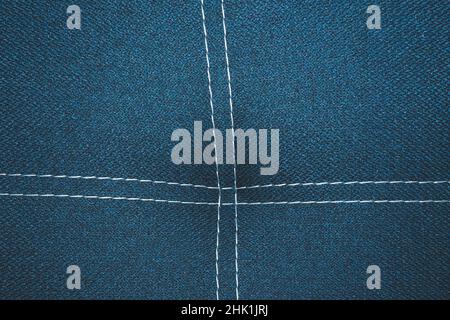 Dark blue denim background with white stitching close up background Stock Photo