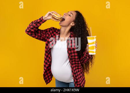 Funny Young Pregnant Lady Holding Burger And Drink Stock Photo