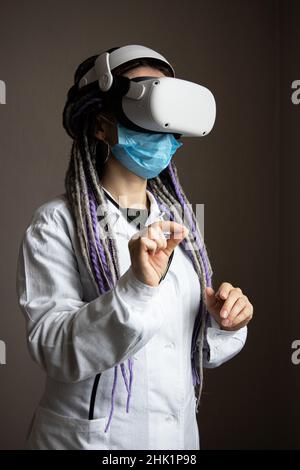 Medical worker is using virtual reality helmet Stock Photo