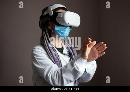 Medical worker is using virtual reality helmet Stock Photo
