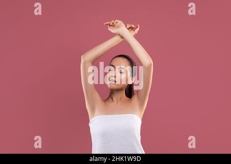 Beautiful asian woman raising hands up, hair removing concept Stock Photo