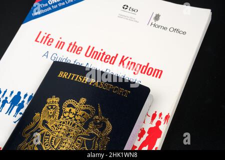 British Passport and offical test book LIFE IN THE UNITED KINGDOM which is required for Indefinite Leave to Remain and UK Citizenship. Stafford, Unite Stock Photo