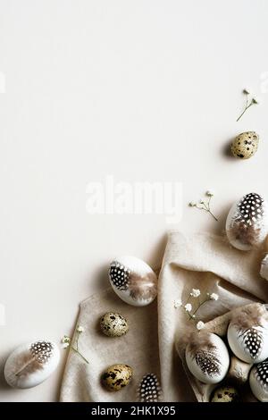 Happy Easter vertical banner design. Trendy Easter card with natural eggs decorated feathers, cloth, gypsophila flowers. Minimal, elegant style. Stock Photo