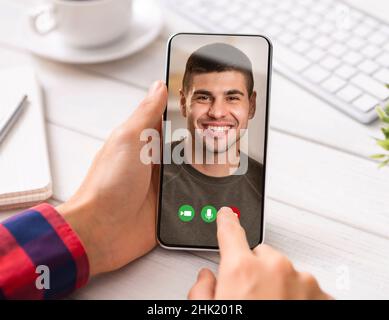Man having video call with friend, sitting at workplace and holding mobile phone with guy photo on screen, collage Stock Photo