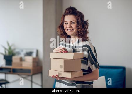 Internet shop worker posing for the camera in the workplace Stock Photo