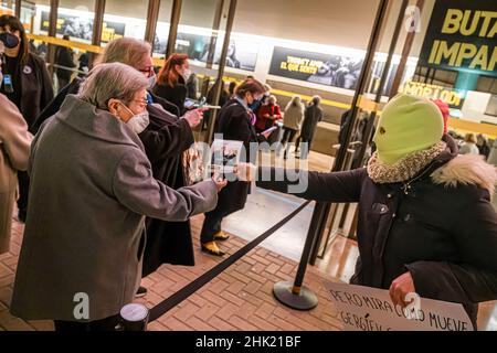 Barcelona, Spain. 01st Feb, 2022. An activist hands out information sheets to the public entering the concert during the protest against the presence of the Russian director Valeri Gérgiev, who is sympathetic to the policies of Russian President Vladimir Putin, who was directing a concert today. Credit: SOPA Images Limited/Alamy Live News Stock Photo