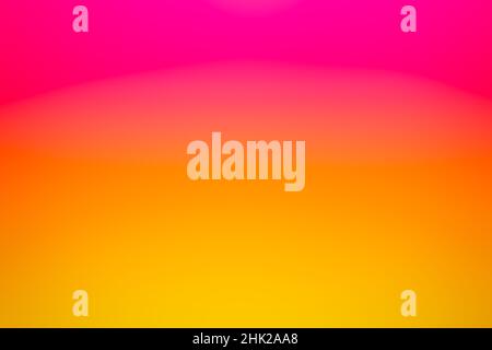 A colorful pink and golden yellow blurred sunset background gradient texture. Stock Photo