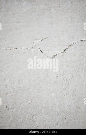 Rough lime wall coating with cracks in the loft style. Stock Photo