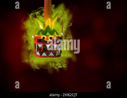 Chinese New Year Decoration--Closeup of colorful red, yellow and green wooden Dragon. surrounded by smoke on a dark blurred bokeh background. Copy spa Stock Photo