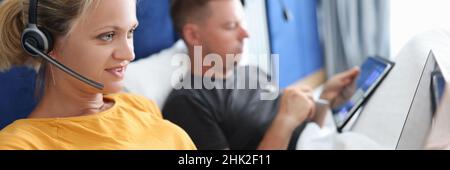 Young couple man and woman work remotely on laptop while lying in bed Stock Photo