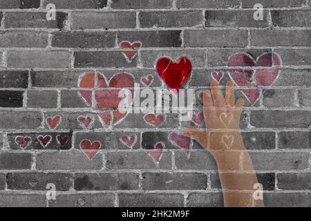 Abstract of brick wall with hearts and hand. Stock Photo
