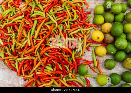 Peppers and limes at market, Vientiane, Capital of Laos, Southeast Asia Stock Photo