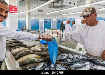 Middle East, Arabian Peninsula, Oman, Muscat, Muttrah. Vendor selling fish at the souk in Muttrah. (Editorial Use Only) Stock Photo