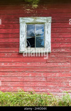 Latah, Washington State, USA. Window on the wall of an old red barn. Stock Photo