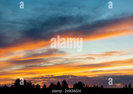 USA, Idaho. Backlit Cirrus Clouds and cloud bank on horizon make a magnificent sunset. Stock Photo