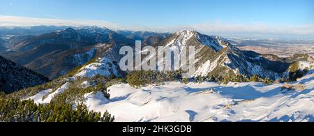 View towards Mittenwald, Wetterstein Mountains, Ammergau Alps and Algau Alps. View from Mt. Herzogstand near lake Walchensee. Germany, Bavaria Stock Photo