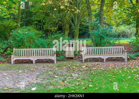 Wooden benches in a garden in autumn, Somme, France Stock Photo