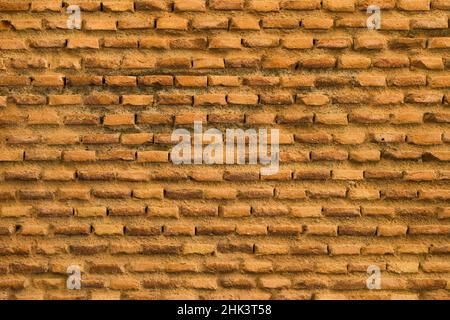 Brick wall in orange tones of an old medieval wall. Concept with highly textured backgrounds. Stock Photo