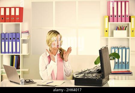 investment advisor businesswoman sitting at office in front of computer. woman with dollar money in bag. office with financial auditor or finance Stock Photo
