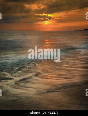 USA, New Jersey, Cape May National Seashore. Sunrise storm clouds over shoreline. Stock Photo