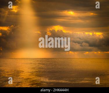 USA, New Jersey, Cape May National Seashore. Sunlight through storm clouds over ocean. Stock Photo