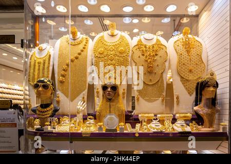 Dubai, UAE, 24.09.21. Golden jewelry - massive golden necklaces, armors, rings and hats displayed in a gold store in Dubai Gold Souk, Deira. Stock Photo