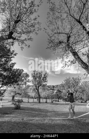 Pete Thomas balancing on slackline in Sully Creek State Park in Medora, North Dakota Stock Photo