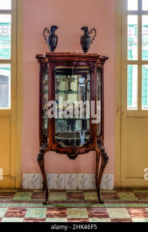 Antique precious wood and glass cupboard in a colonial style room in the Decorative Arts Museum. The 'Museo de Artes Decorativas' is a famous place an Stock Photo