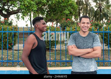 Two friends in sportswear having fun in the street Stock Photo