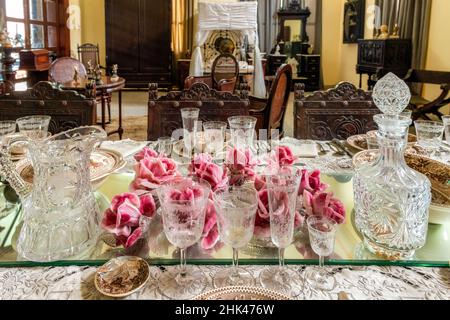 Red flowers centerpiece in a set-up dining room table in the Decorative Arts Museum. The 'Museo de Artes Decorativas' is a famous place and a major to Stock Photo