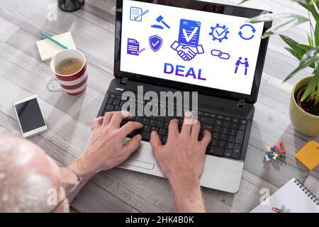 Deal concept shown on a laptop used by a man Stock Photo
