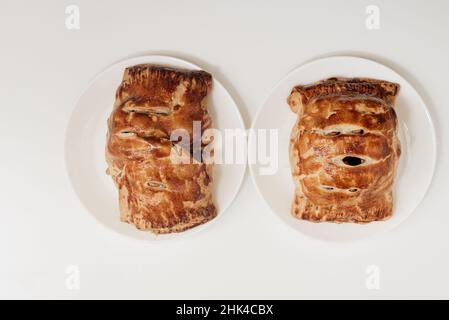 Two pieces of apple strudel, homemade, resting on a white surface  Stock Photo