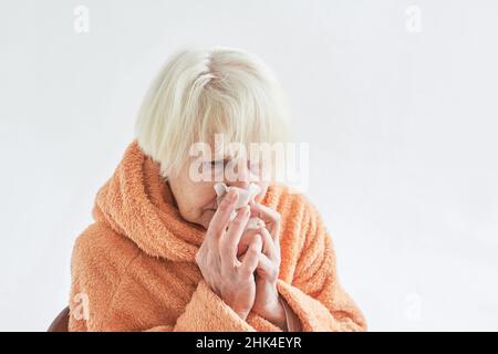 senior ill woman freezing cold at home. Health care, crisis, oldness concept Stock Photo