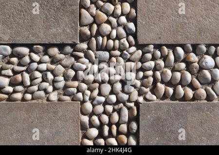 Decorative flooring pattern with concrete blocks and pebble, top view Stock Photo