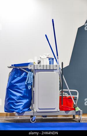 Professional cleaning trolley set with tools and utensils. Cleaning service Stock Photo