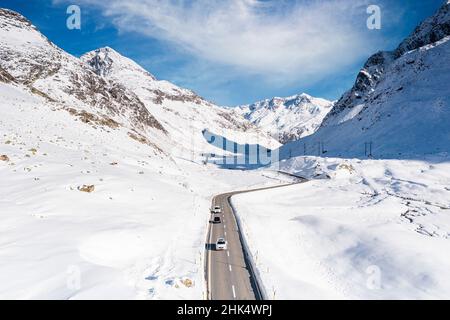 Aerial view of cars driving on mountain road in winter, Julier Pass, Albula district, Engadine, canton of Graubunden, Switzerland, Europe Stock Photo