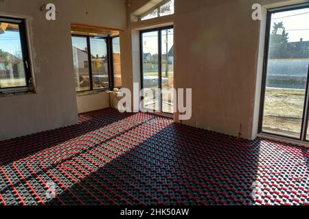 fllor heating in the house under construction with windows and light Stock Photo