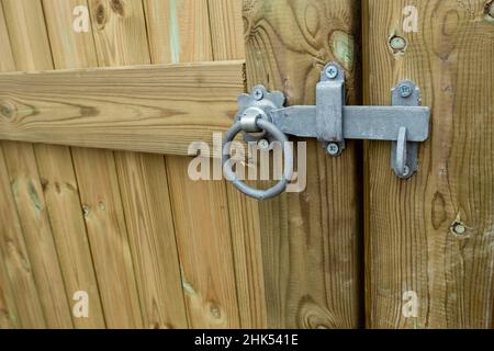 Ring latch on a wooden garden gate. Stock Photo