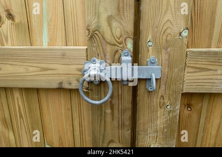 Ring latch on a wooden garden gate. Stock Photo