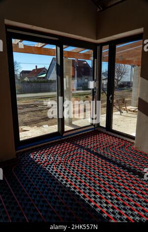 fllor heating in the house under construction with windows and light Stock Photo