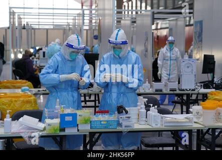 File photo dated 31-01-2022 of PCR testing staff wearing hazmat suits work at a PCR testing site at Beijing International Airport. Hazmat suits and sore noses serve as an unlikely welcome to Beijing as visitors prepare to plunge into the ‘closed-loop’ system for the duration of the Winter Olympics, which officially open in the Chinese capital on Friday. Issue date: Wednesday February 2, 2022. Stock Photo