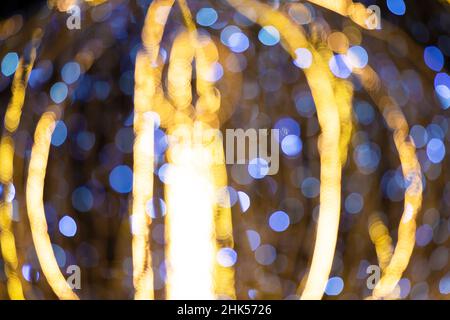 Spots of blue and gold bokeh on a dark background. Stock Photo