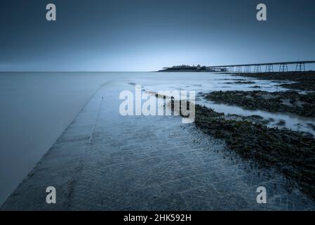 The Anchor Head slipway and Birnbeck Pier in the Bristol Channel at Weston-super-Mare, North Somerset, England. Stock Photo