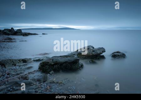 The shore of the Bristol Channel at Anchor Head in Weston-super-Mare with Brean Down promontory beyond, North Somerset, England. Stock Photo