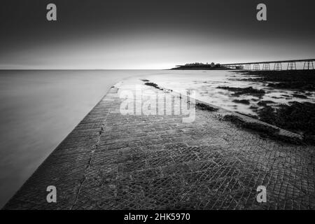 The Anchor Head slipway and Birnbeck Pier in the Bristol Channel at Weston-super-Mare, North Somerset, England. Stock Photo