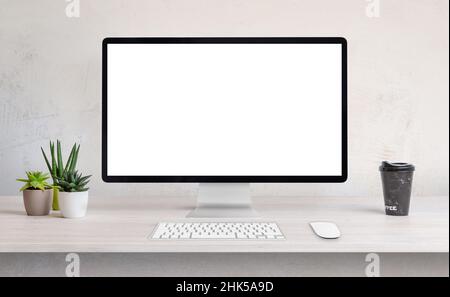 Computer display on work desk with white, isolated screen for web page presentation Stock Photo